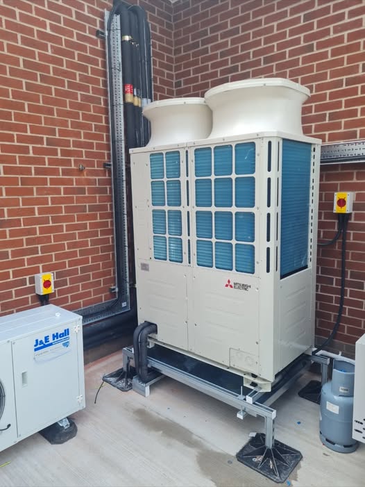 Mitsubishi Electric VRF external condenser unit installed against brickwork