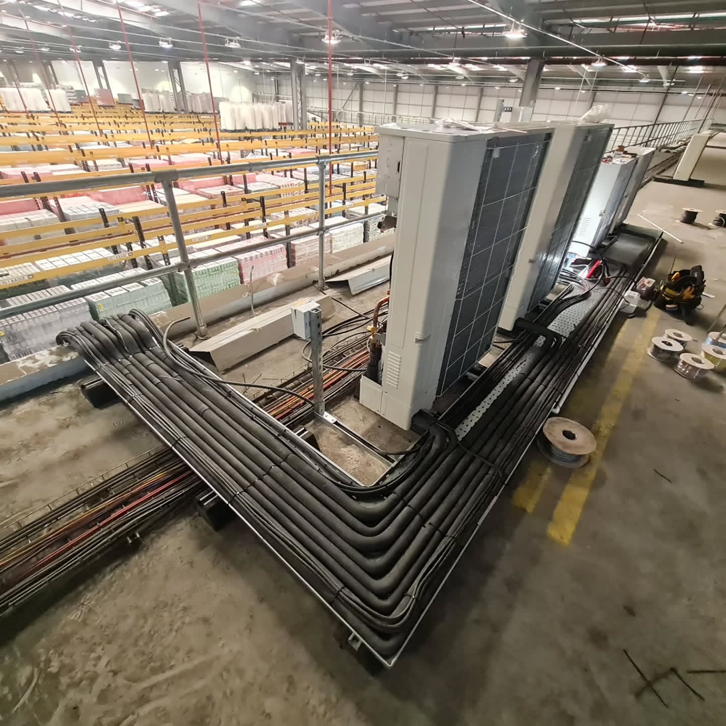 Condensing units on a mezzanine plant deck with insulated refrigerant pipework